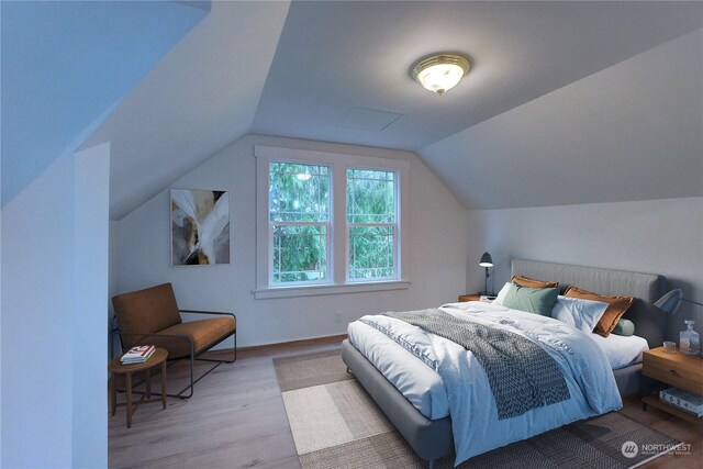 bedroom with light hardwood / wood-style flooring and lofted ceiling