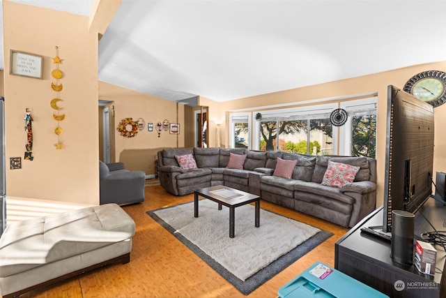 living room with lofted ceiling and hardwood / wood-style flooring