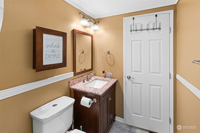 bathroom with tile patterned floors, vanity, and toilet