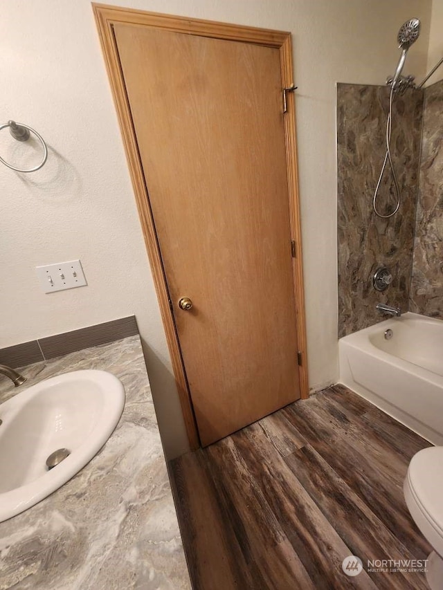 full bathroom with hardwood / wood-style floors, vanity, toilet, and tub / shower combination