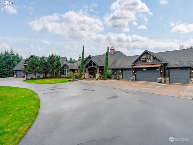 view of front of house with a front yard and a garage