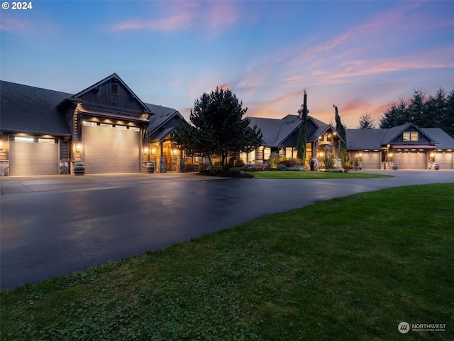 view of front of home with a lawn and a garage