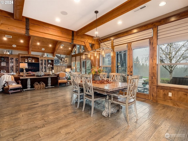 dining room with vaulted ceiling with beams, wood-type flooring, wooden walls, and french doors