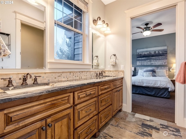 bathroom with vanity, ceiling fan, and backsplash