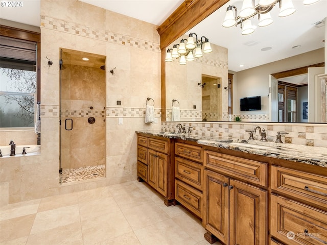 bathroom featuring tile patterned floors, vanity, an enclosed shower, and tile walls