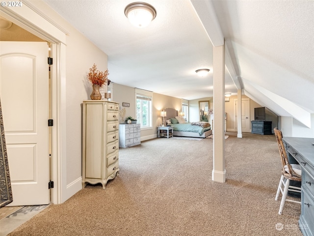 unfurnished bedroom featuring a textured ceiling, carpet floors, and lofted ceiling