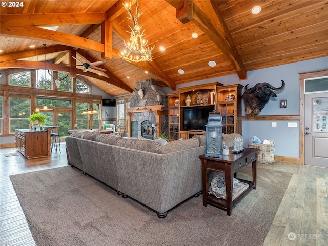 living room with wooden ceiling, beamed ceiling, a fireplace, ceiling fan with notable chandelier, and light wood-type flooring