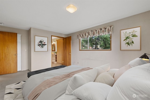 carpeted bedroom featuring ensuite bathroom