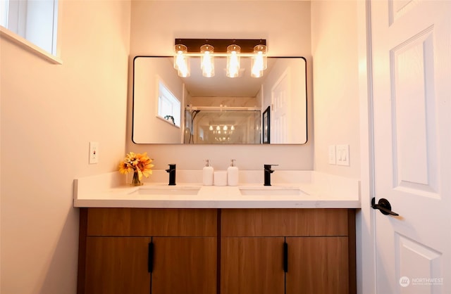 bathroom featuring plenty of natural light, walk in shower, and vanity