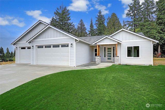 view of front of home featuring covered porch, a garage, and a front lawn