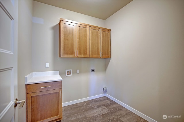 laundry room featuring cabinets, washer hookup, dark hardwood / wood-style flooring, and electric dryer hookup