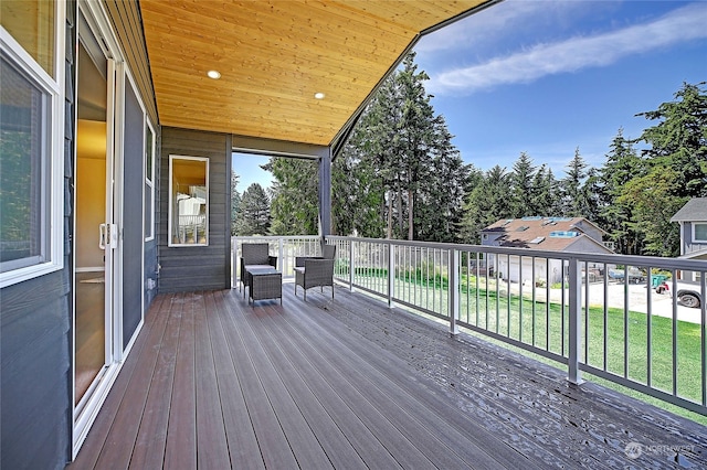 wooden deck with a lawn