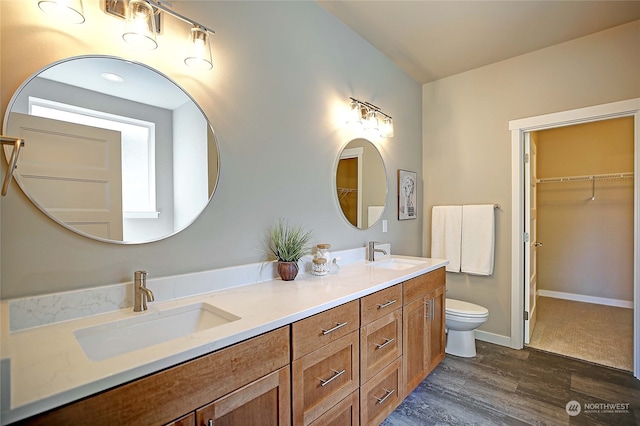 bathroom featuring hardwood / wood-style floors, vanity, and toilet