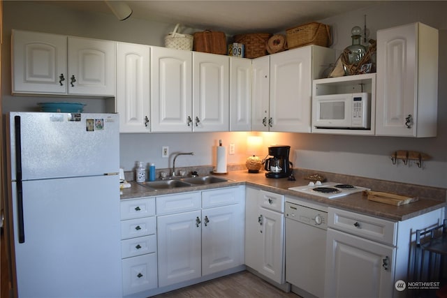 304 14th St NW Unit 209, Long Beach, WA 98631 - kitchen featuring white appliances, white cabinets, wood finished floors, and open shelves