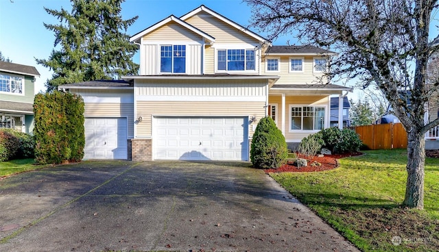 view of front of home with a front yard and a garage