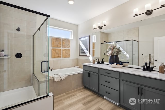 bathroom with vanity, wood-type flooring, and independent shower and bath