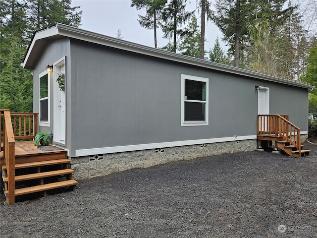 back of house with a wooden deck