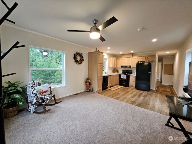 interior space featuring light brown cabinetry, light wood-type flooring, ceiling fan, crown molding, and black appliances