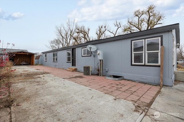 back of house with a patio area and central AC unit