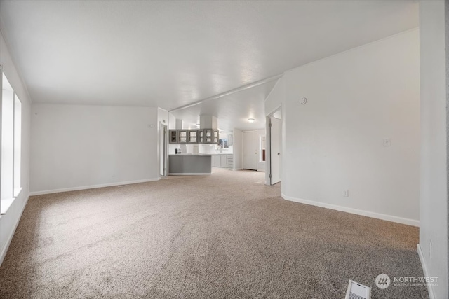 unfurnished living room featuring light carpet