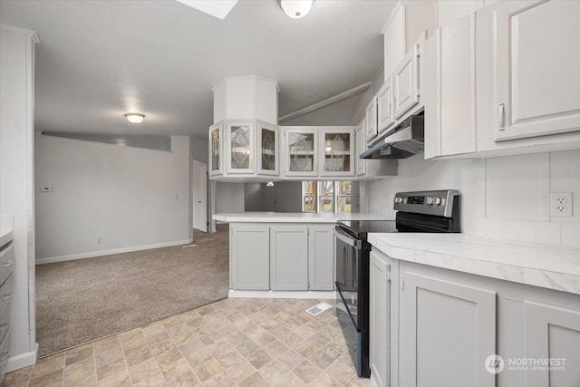 kitchen featuring white cabinets, light colored carpet, and black range with electric cooktop