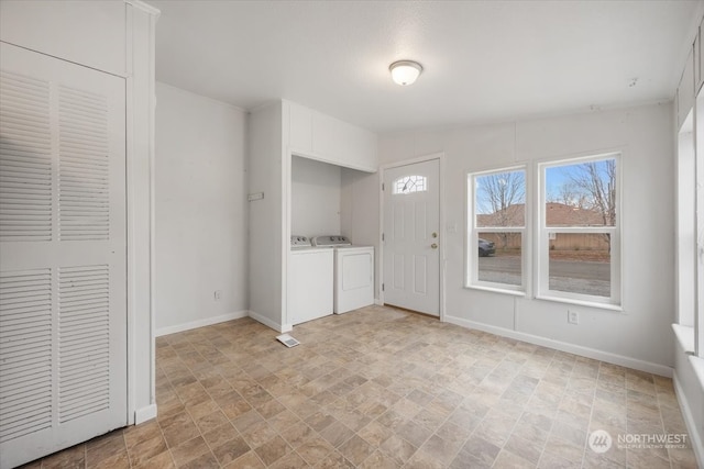 clothes washing area with separate washer and dryer