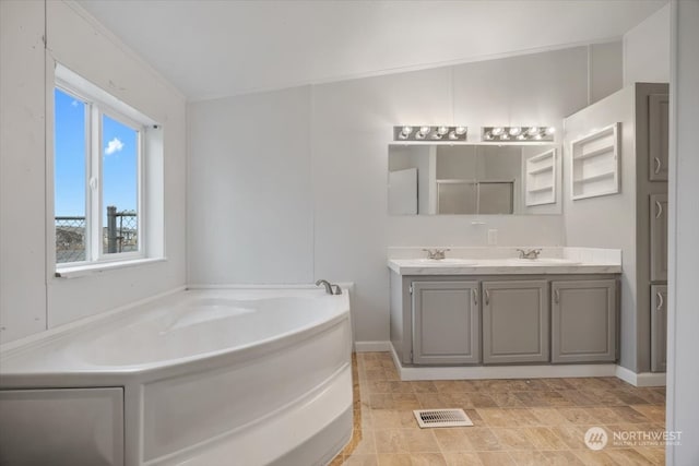 bathroom featuring a bathing tub and vanity