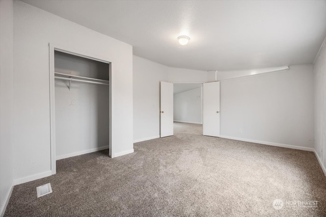 unfurnished bedroom with carpet and a closet