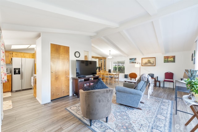 living room featuring vaulted ceiling with beams and light hardwood / wood-style flooring