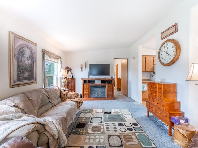 living room featuring light colored carpet and vaulted ceiling