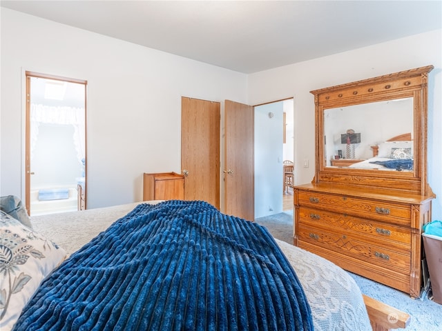 carpeted bedroom with ensuite bathroom