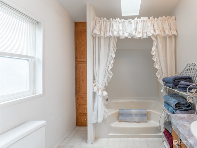 bathroom featuring toilet, vanity, and a bathing tub