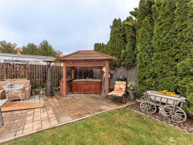 view of patio / terrace featuring a gazebo and a hot tub