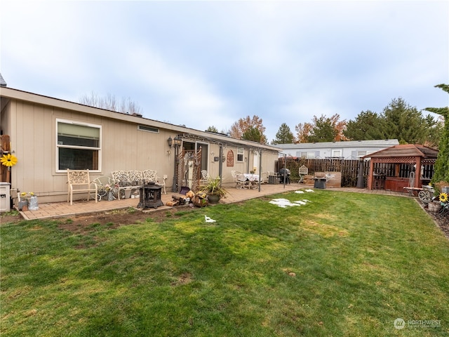 rear view of house featuring a gazebo, a patio, and a yard