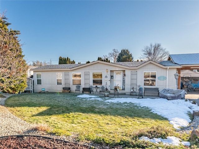 view of front of property with a patio and a front yard