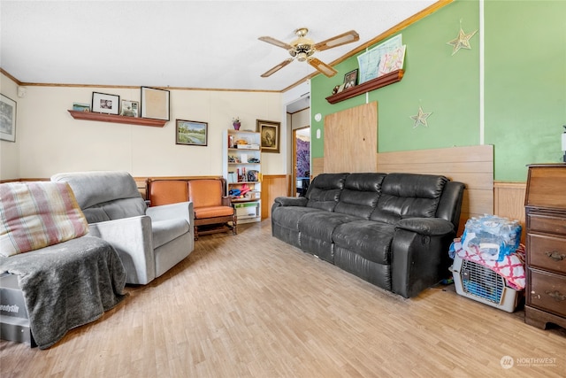 living room featuring crown molding, ceiling fan, light hardwood / wood-style floors, and vaulted ceiling