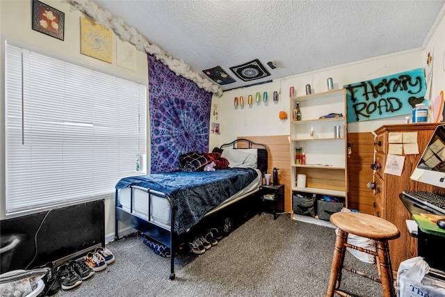 carpeted bedroom with a textured ceiling