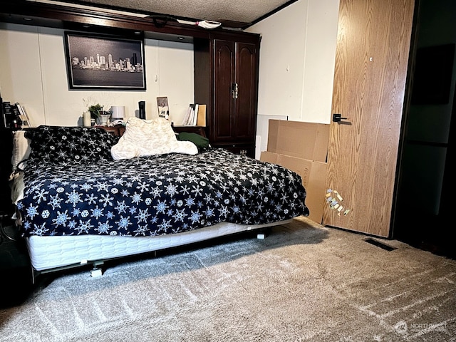 carpeted bedroom with a textured ceiling