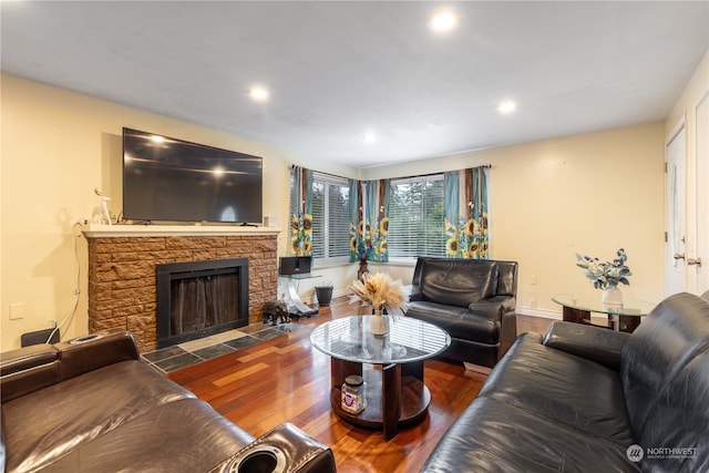 living room with a fireplace and dark hardwood / wood-style flooring