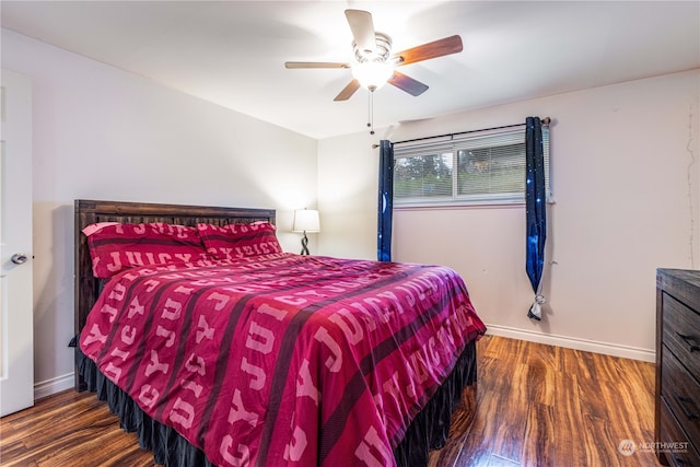 bedroom with ceiling fan and dark wood-type flooring