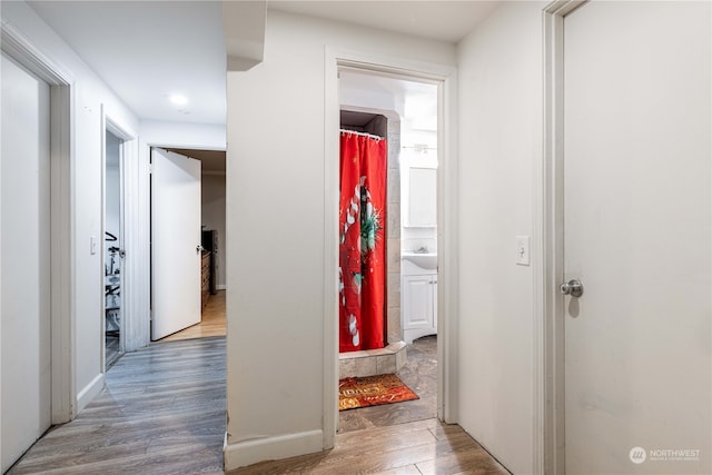 corridor featuring hardwood / wood-style floors and sink