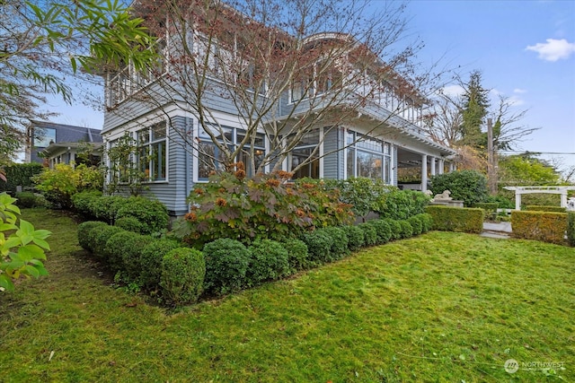 view of side of home featuring a lawn