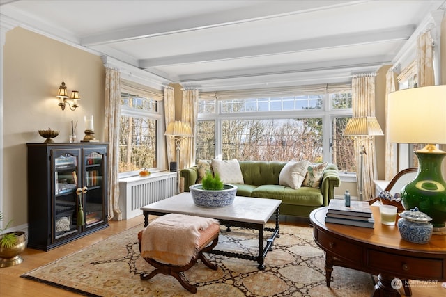 sunroom featuring beam ceiling and radiator heating unit