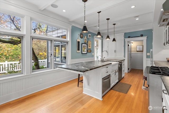 kitchen featuring light hardwood / wood-style floors, a kitchen bar, and white cabinetry