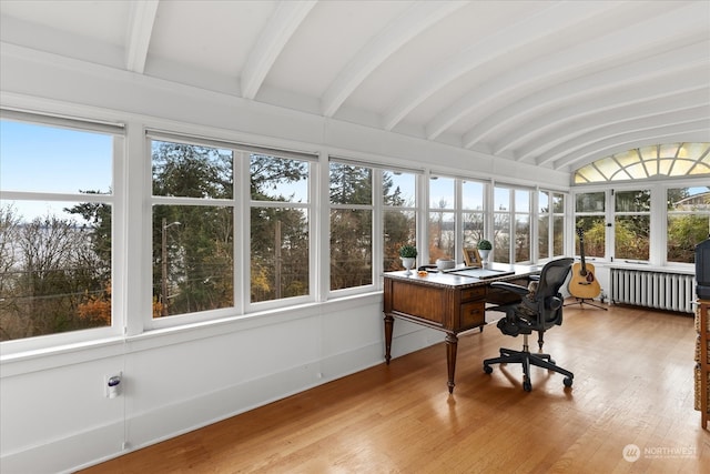 sunroom / solarium with radiator heating unit and lofted ceiling with beams