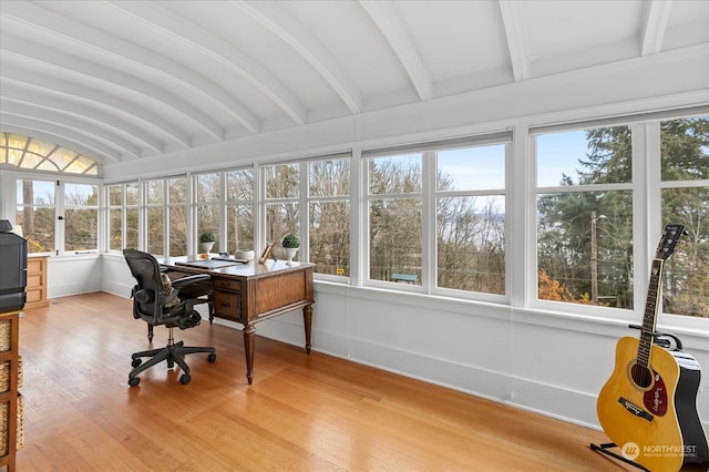 office featuring hardwood / wood-style floors and lofted ceiling with beams