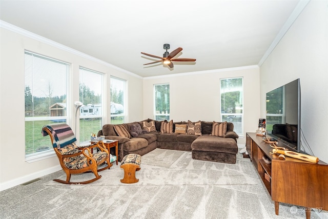 carpeted living room featuring ceiling fan and ornamental molding