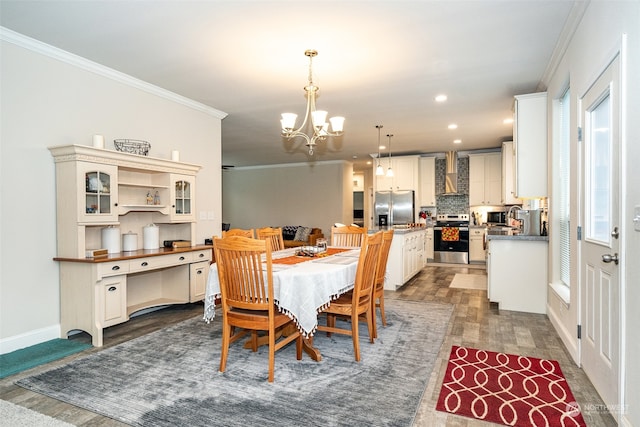 dining space featuring crown molding, dark wood-type flooring, and an inviting chandelier