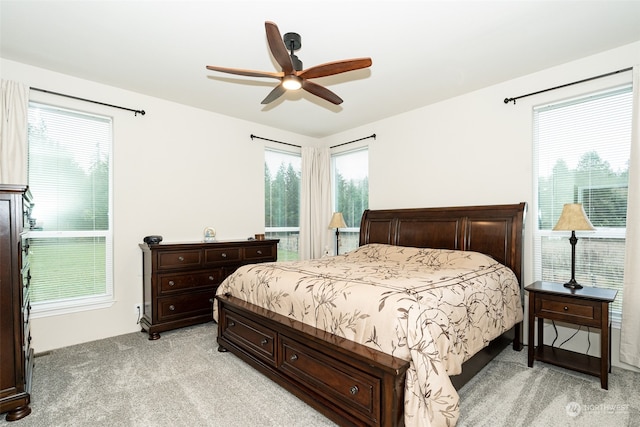 bedroom with ceiling fan and light colored carpet