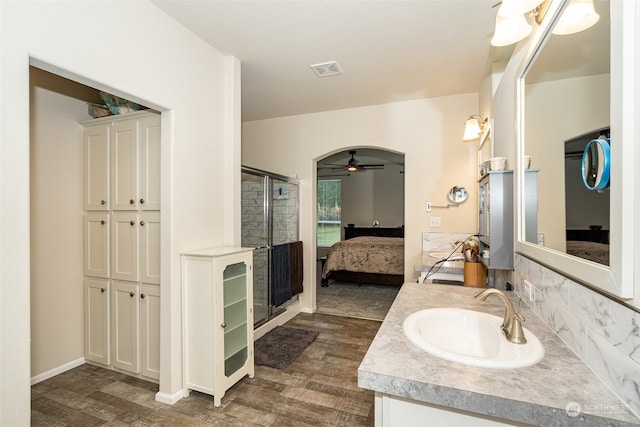 bathroom with ceiling fan, wood-type flooring, walk in shower, and vanity